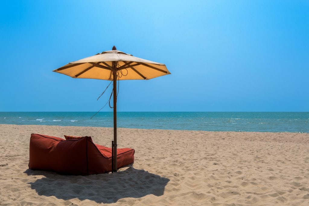Comfortable chair on a beach with an umbrella.  Pixabay download.
